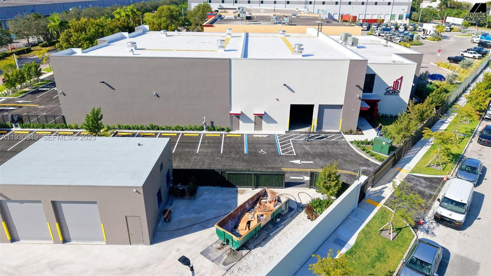 An aerial view shows a commercial building with a parking lot and a dumpster — 10941 NW 123rd St, Medley FL 33178, MEDLEY, FL