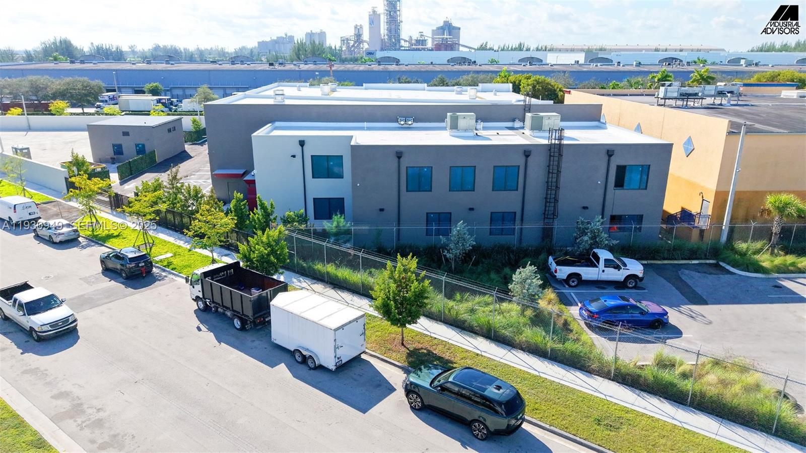 An aerial view shows a two-story commercial building with a parking lot and surrounding landscaping — 10941 NW 123rd St, Medley FL 33178, MEDLEY, FL