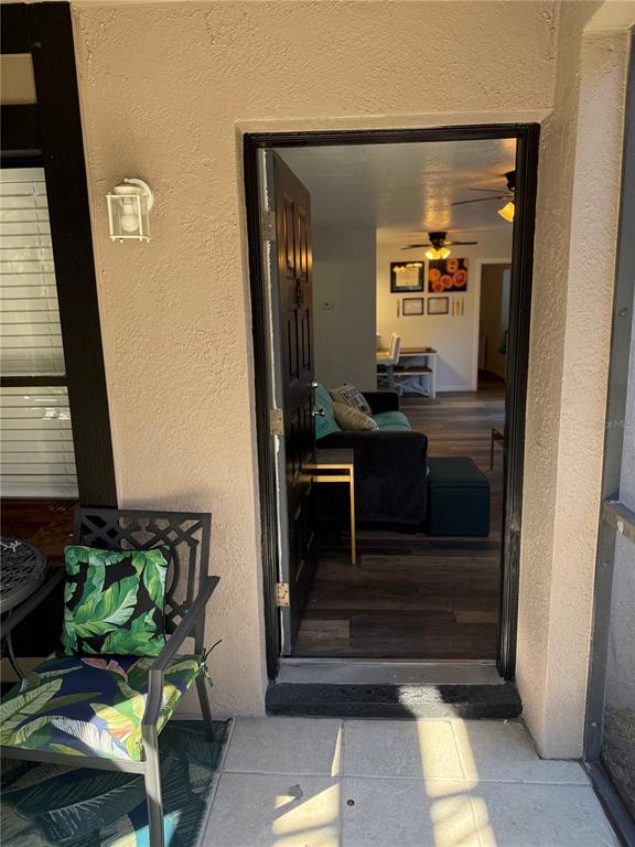 A view from a screened porch through an open door into a furnished living room — 4025 ANGEL OAK COURT UNIT 103, TAMPA, FL