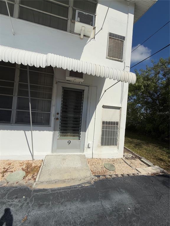 The exterior of a white building features a door labeled nine with a metal screen — 5895 18TH STREET N UNIT 9, ST PETERSBURG, FL