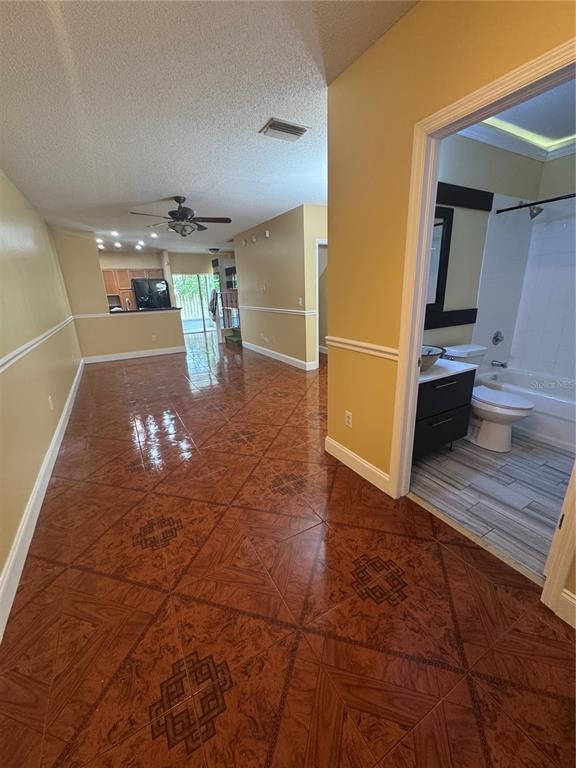 A view from a hallway looking into a living area and a bathroom with tile flooring — 6229 OSPREY LAKE CIRCLE, RIVERVIEW, FL
