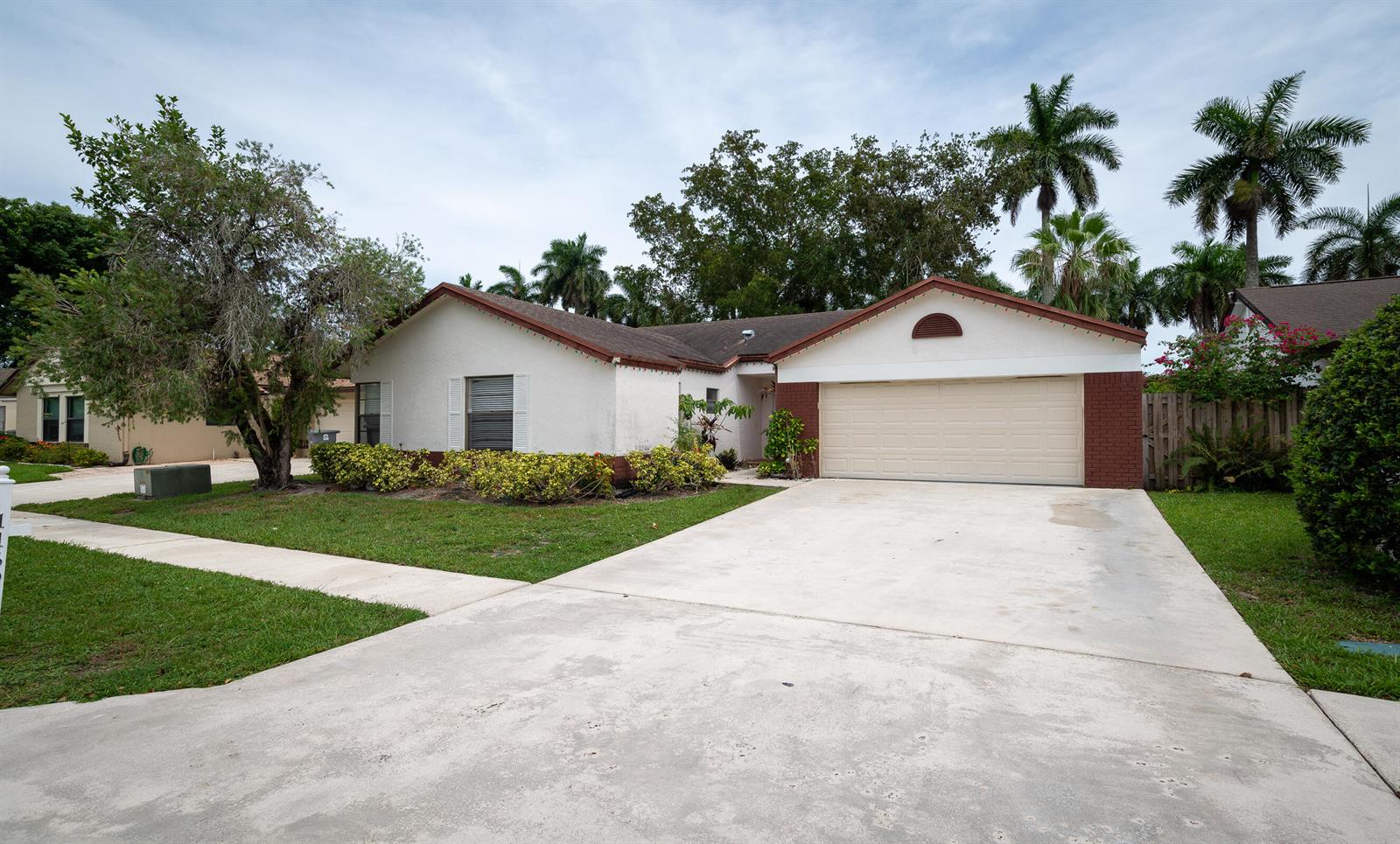 A single-story house with a white stucco exterior, brown roof, and a two-car garage — 11690 Timberwood Road, Boca Raton FL 33428, BOCA RATON, FL