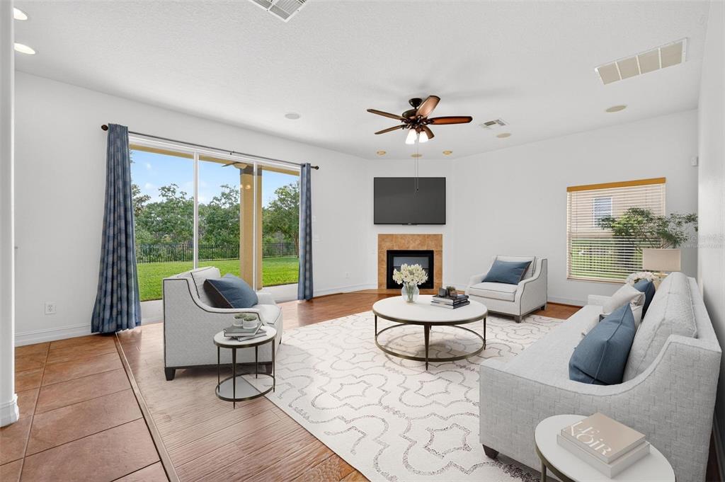 A living room features tile floors, a fireplace, a ceiling fan, and sliding glass doors — 6054 TREMAYNE DRIVE, MOUNT DORA, FL