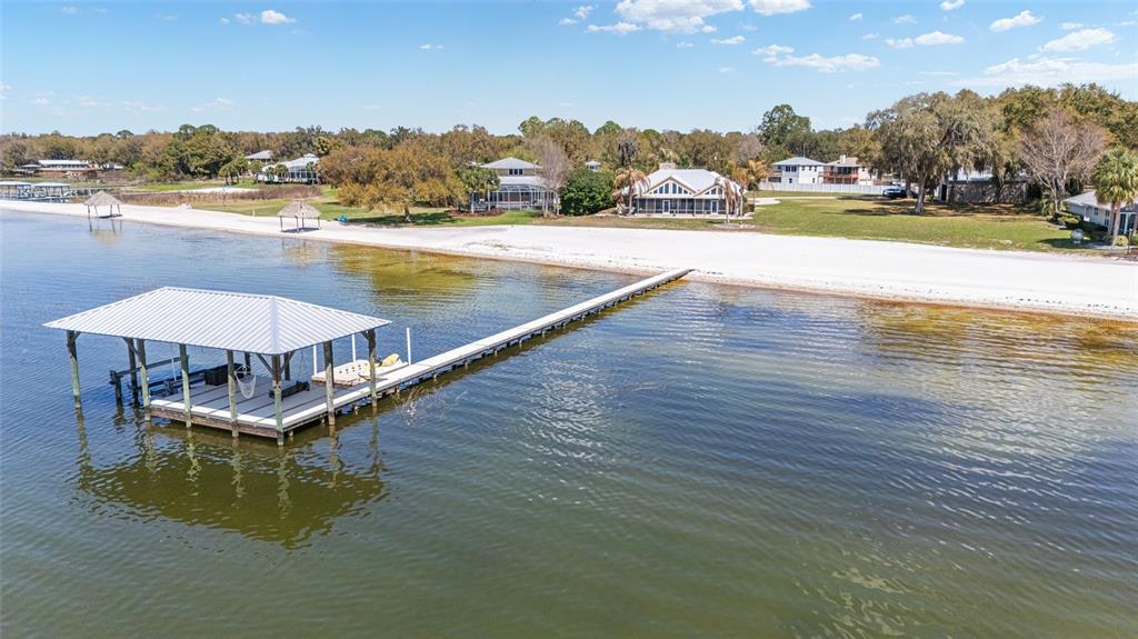 An aerial view of a waterfront house with a circular driveway and two private docks — 12830 SE 144TH AVENUE, OCKLAWAHA, FL