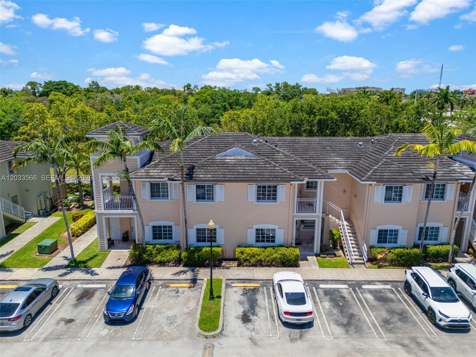 An aerial view shows a two-story apartment building with a parking lot in front — 2741 NE 4th St # 202, Homestead FL 33033, HOMESTEAD, FL