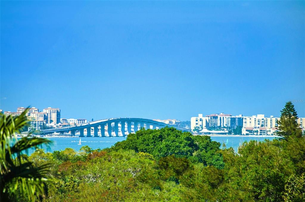 A view of a bridge spanning across water with coastal buildings in the background — 139 BLUFF VIEW DRIVE UNIT 407, BELLEAIR BLUFFS, FL