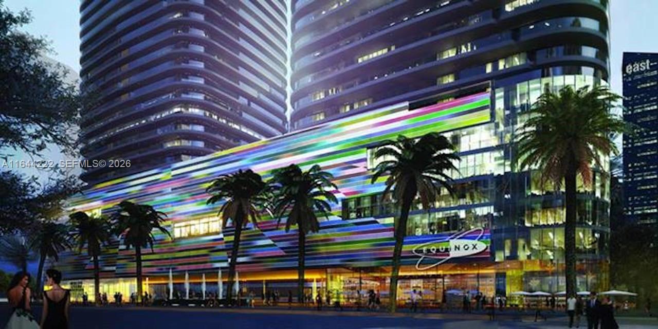 This is a rendering of a modern high-rise building featuring a colorful, multi-striped facade — 45 SW 9th St # 1005, Miami FL 33130, MIAMI, FL