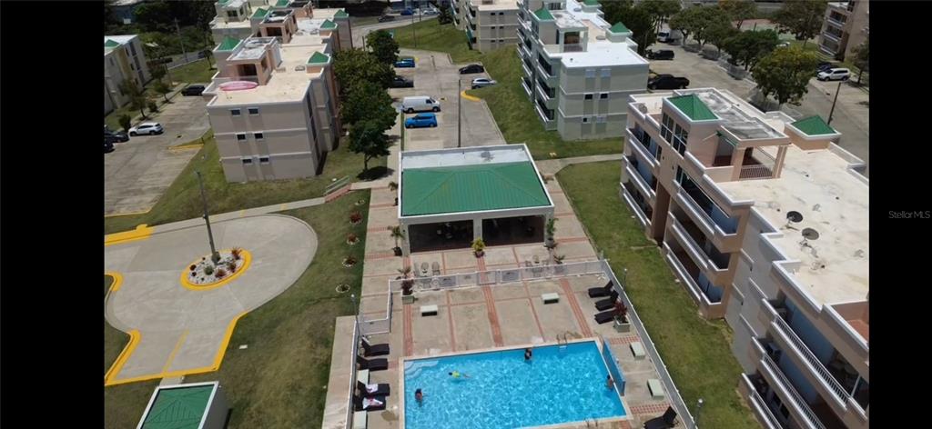 An aerial view shows a swimming pool, a covered patio area, and several apartment buildings — Cond Vista Real E 3 -23 -B VILLAGE E UNIT 23, FAJARDO, PR