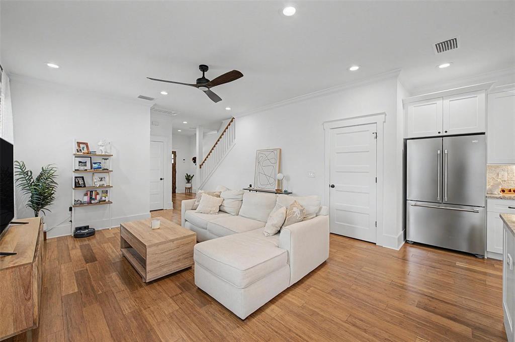 A living room features a sectional sofa, wooden coffee table, and stainless steel refrigerator — 911 E OSBORNE AVENUE UNIT A, TAMPA, FL