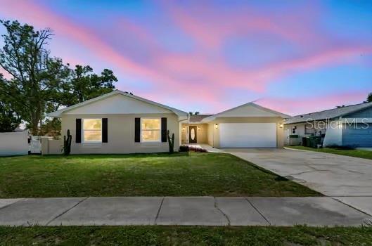 A covered patio with a swimming pool, ceiling fans, and a white painted brick wall — 2959 MAPLE COURT, DUNEDIN, FL