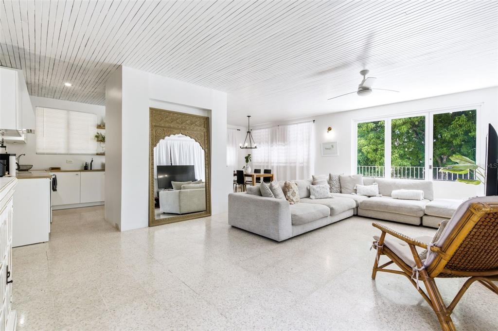 A bright, open-concept living room features a large ornate mirror, sectional sofa, and terrazzo flooring — CARR. 686 KM 1.5 BO. TIERRAS NUEVAS SALIENTES, MANATI, PR