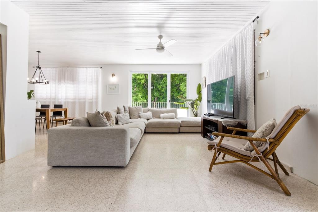 A living room features a large sectional sofa, a rattan chair, and terrazzo flooring — CARR. 686 KM 1.5 BO. TIERRAS NUEVAS SALIENTES, MANATI, PR