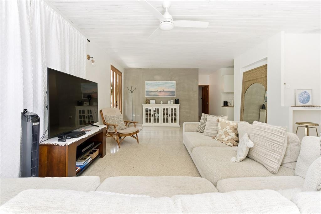 A living room features a large sectional sofa, a television on a wooden stand, and tile flooring — CARR. 686 KM 1.5 BO. TIERRAS NUEVAS SALIENTES, MANATI, PR
