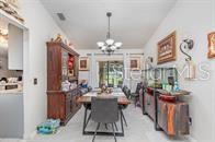 A dining room features a wooden hutch, a rectangular table with chairs, and a chandelier — 630 HOBSON TERRACE, DELTONA, FL