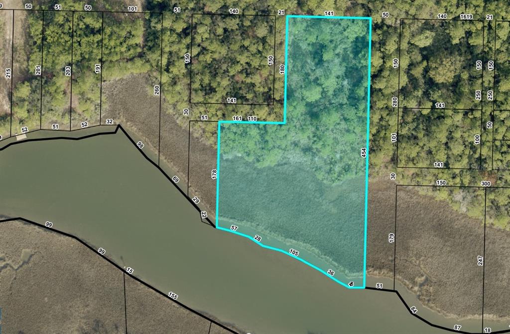 This is a satellite map showing a highlighted parcel of land bordering a body of water — 5599 DEL REY STREET, MILTON, FL