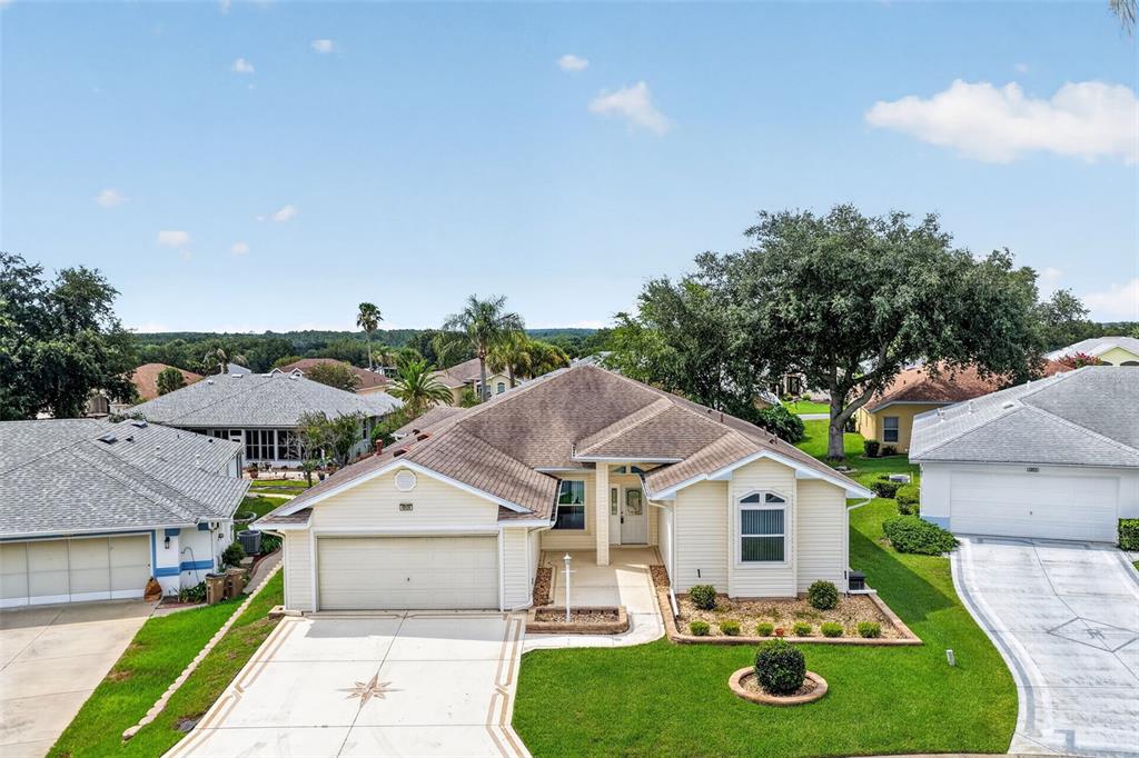 An aerial view of a single-story suburban house with a tan exterior and garage — 4808 KILT COURT, LEESBURG, FL
