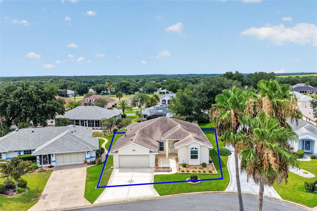 An aerial view shows a single-story suburban house with a tan exterior and garage — 4808 KILT COURT, LEESBURG, FL