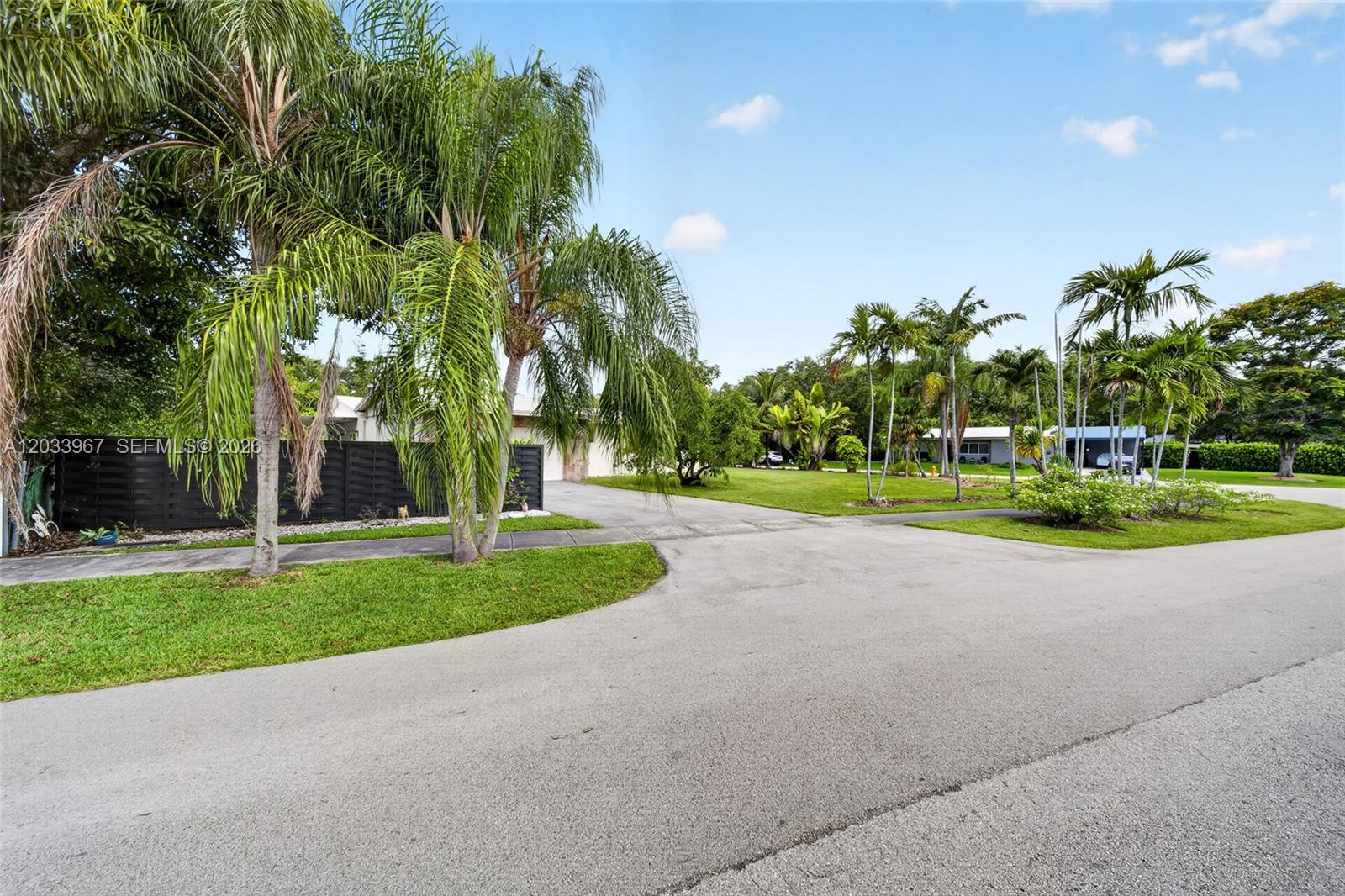 A paved driveway leads to a house partially obscured by palm trees and landscaping — 8250 SW 118th Ter, Miami FL 33156, MIAMI, FL