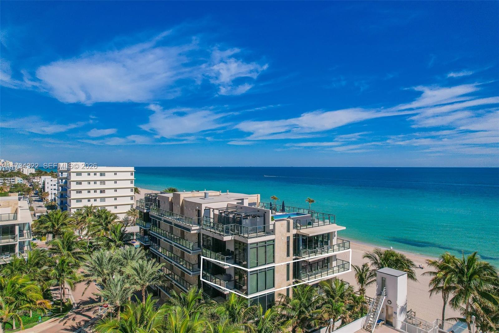 A modern open-concept living and dining area features floor-to-ceiling windows overlooking the ocean — 2205 S Surf Rd # 4A, Hollywood FL 33019, HOLLYWOOD, FL