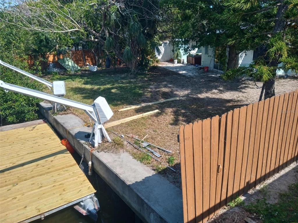 A laundry area features a stacked washer and dryer unit next to a small vanity sink — 6631 ROSATI LANE S, ST PETERSBURG, FL