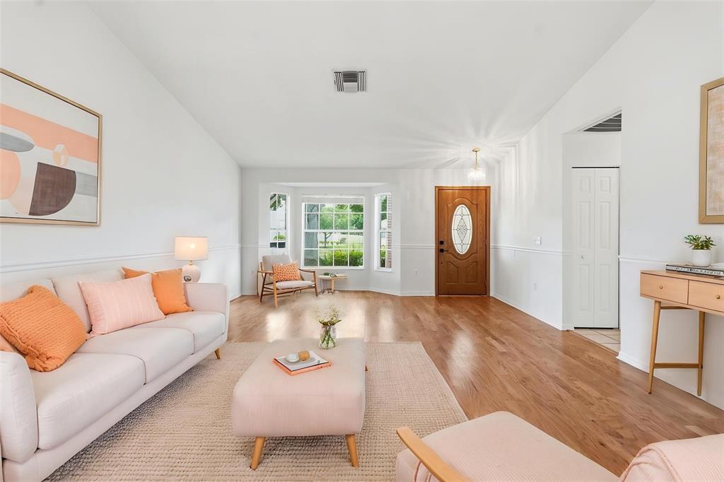 A kitchen with oak cabinets, white appliances, tile flooring, and a view of the outdoors — 1444 CANBERLEY COURT, TRINITY, FL