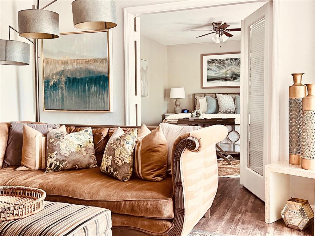 A living room with a brown sofa leads into a bedroom through double doors — 151 N ORLANDO AVENUE UNIT 203, WINTER PARK, FL