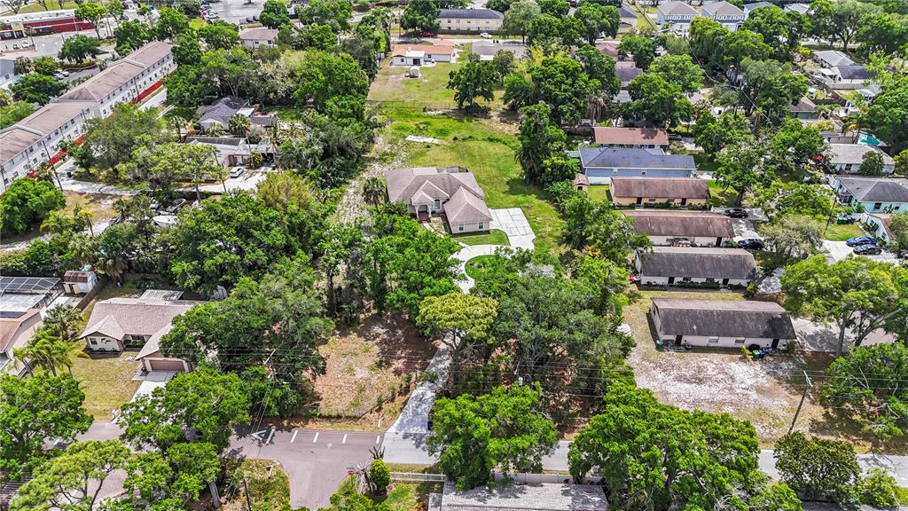 An aerial view shows a residential property with a house, driveway, and surrounding trees — 3902 W ELROD AVENUE, TAMPA, FL