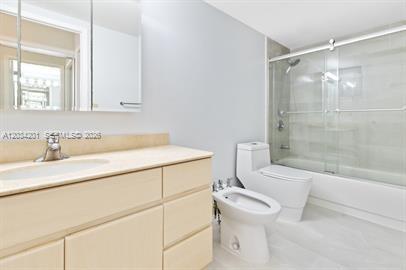 A bathroom features a light wood vanity, a toilet, a bidet, and a glass-enclosed shower — 2500 Parkview Dr # 1216, Hallandale Beach FL 33009, HALLANDALE BEACH, FL
