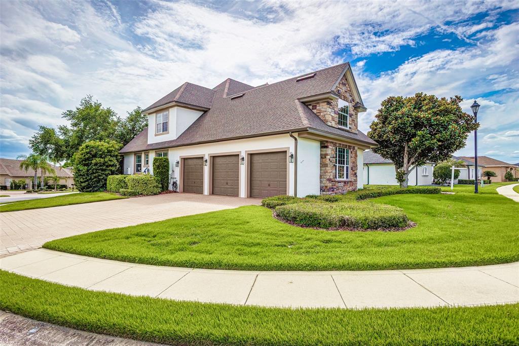 A screened-in patio features a swimming pool with a spa and a paved deck — 7535 REFLECTIONS LAKE DRIVE, LAKELAND, FL