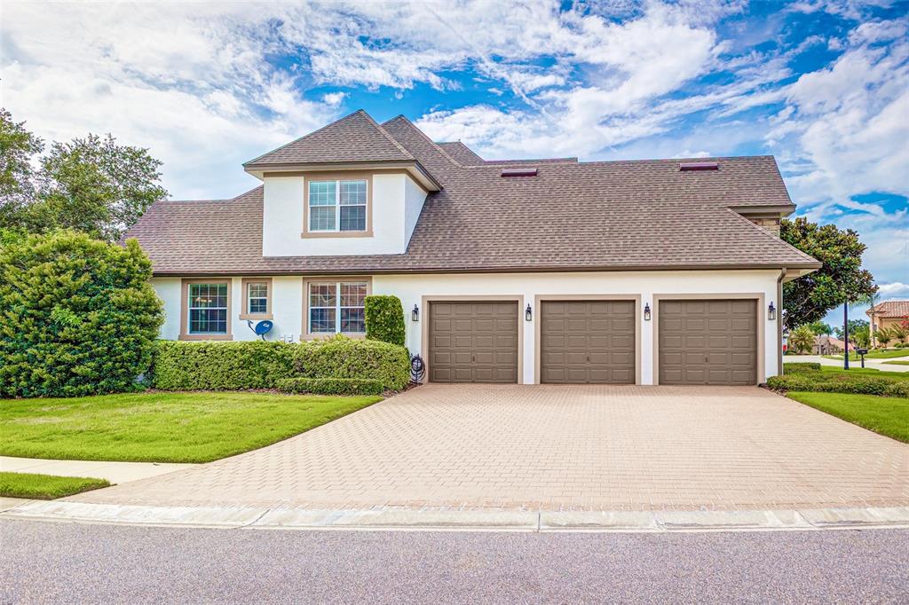 A screened-in patio features a stone outdoor kitchen, a swimming pool, and a spa — 7535 REFLECTIONS LAKE DRIVE, LAKELAND, FL