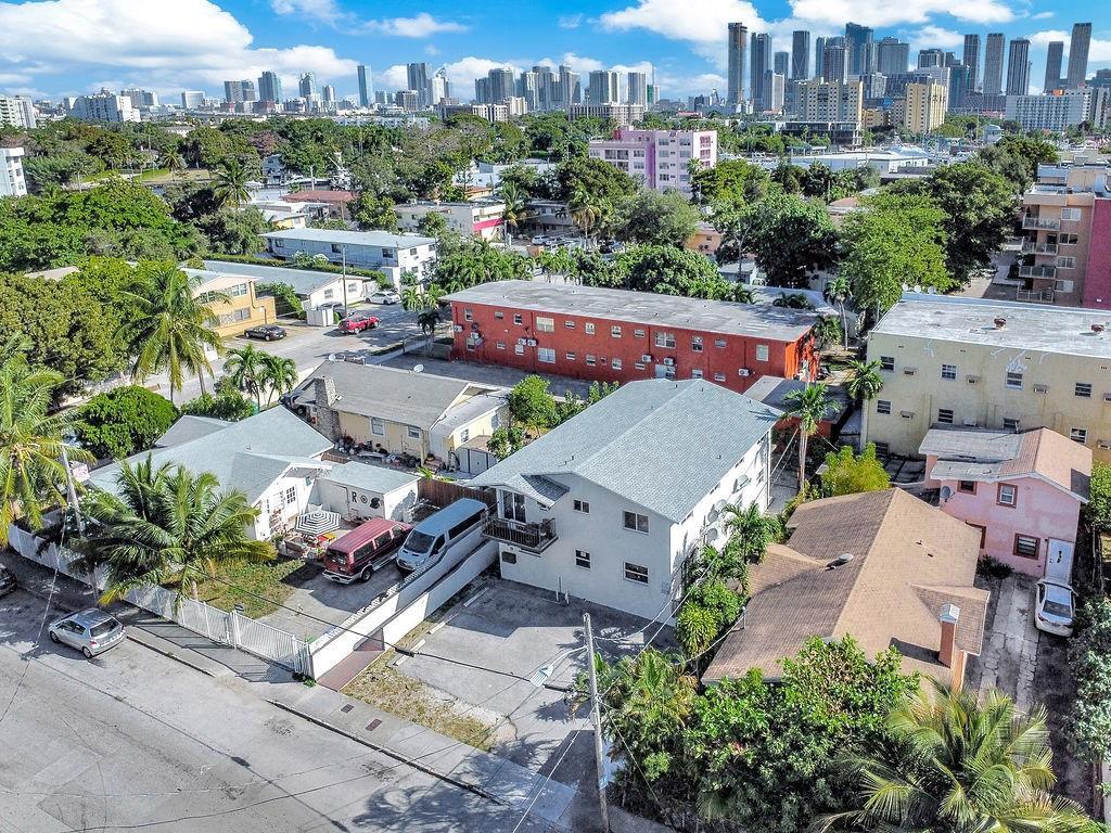An aerial view shows a residential neighborhood with several multi-story apartment buildings and houses — 429 NW 10th Avenue, Miami FL 33128, MIAMI, FL