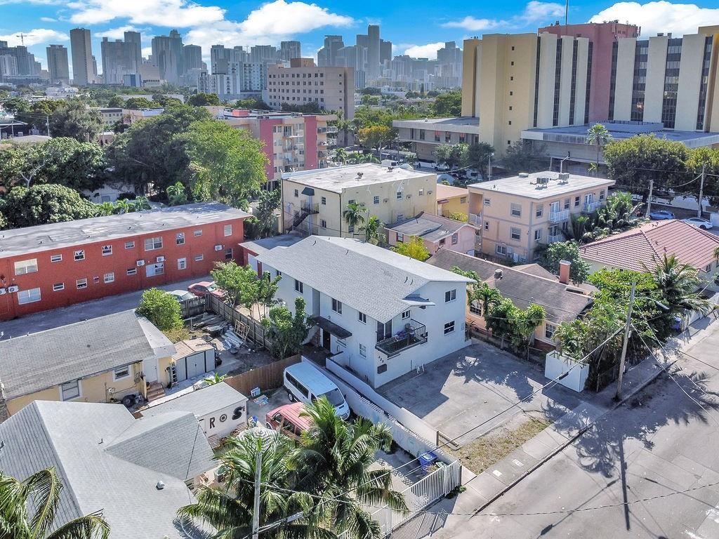 An aerial view shows a white multi-unit residential building surrounded by neighboring houses and apartments — 429 NW 10th Avenue, Miami FL 33128, MIAMI, FL