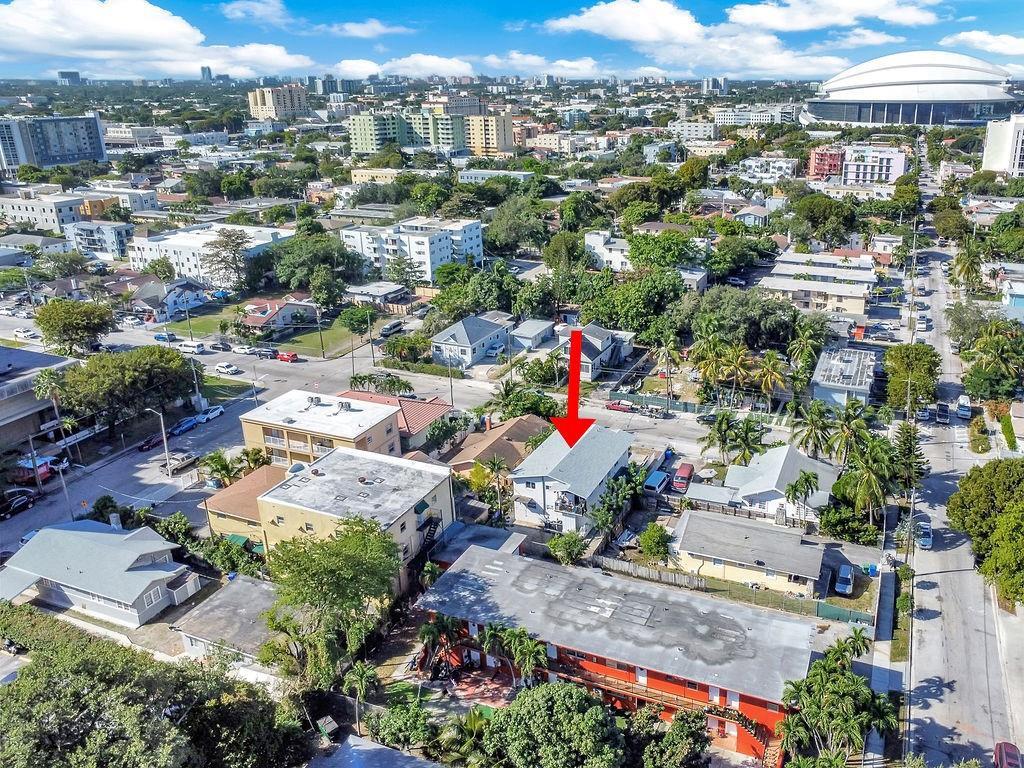An aerial view of a residential neighborhood with a red arrow pointing to a house — 429 NW 10th Avenue, Miami FL 33128, MIAMI, FL