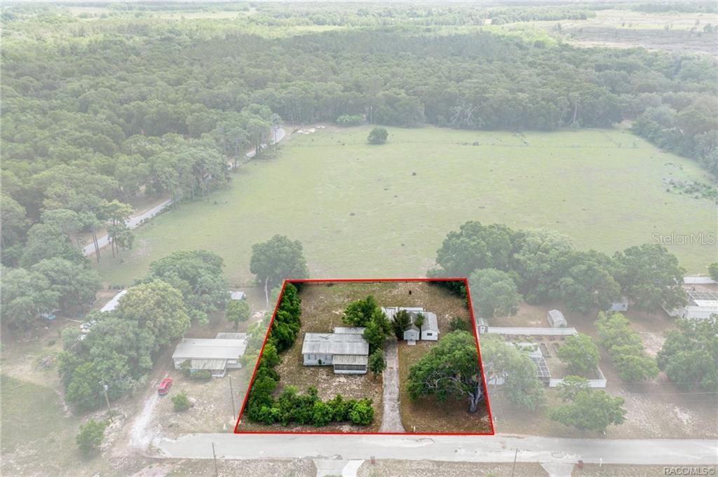 An aerial view shows a house on a rectangular lot outlined in red — 8415 S LINDEN POINT, FLORAL CITY, FL