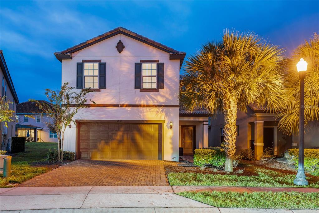 A carpeted staircase leads up from a tiled entryway into a living room with furniture — 5505 MISTY OAK CIRCLE, DAVENPORT, FL