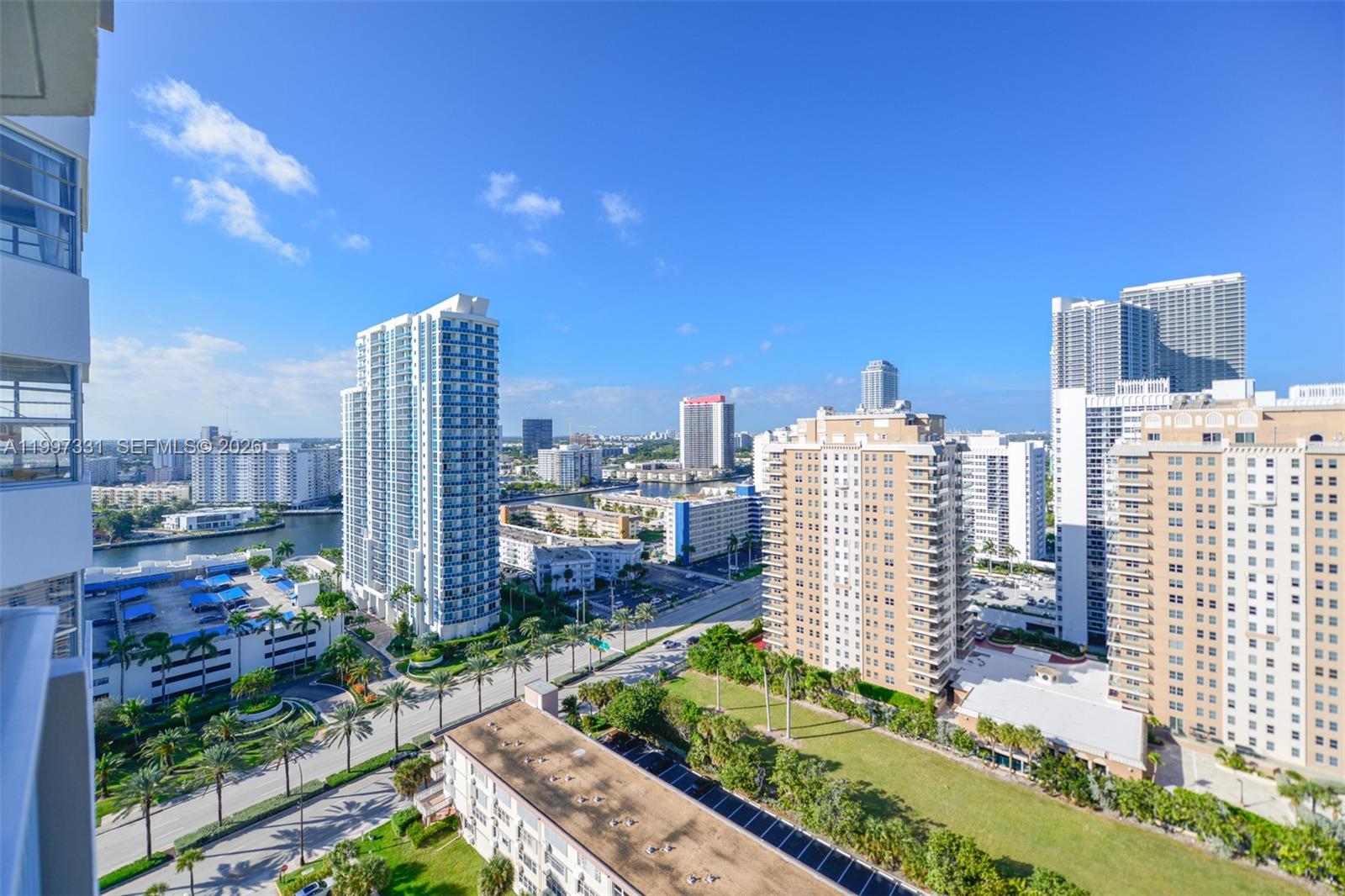An elevated view shows a city skyline with multiple high-rise buildings and a street — 1950 S Ocean Dr # 20D, Hallandale Beach FL 33009, HALLANDALE BEACH, FL