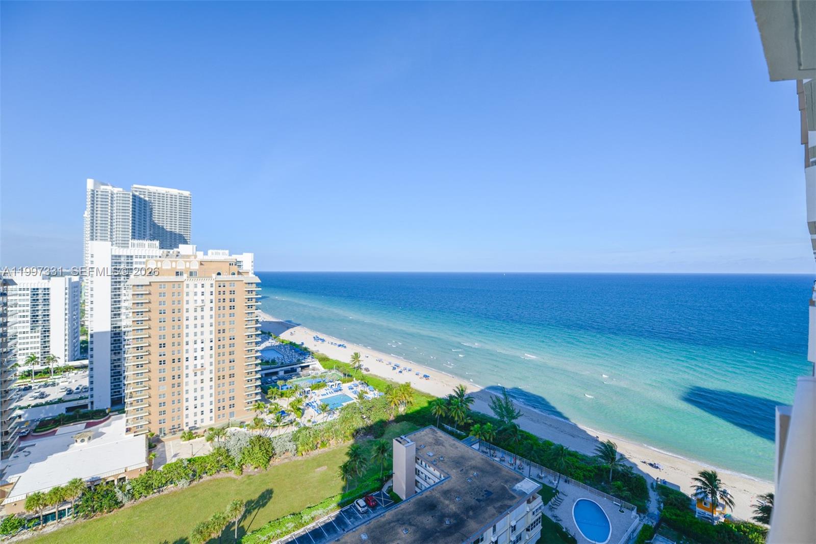 An elevated view of a sandy beach, ocean, and surrounding high-rise buildings — 1950 S Ocean Dr # 20D, Hallandale Beach FL 33009, HALLANDALE BEACH, FL