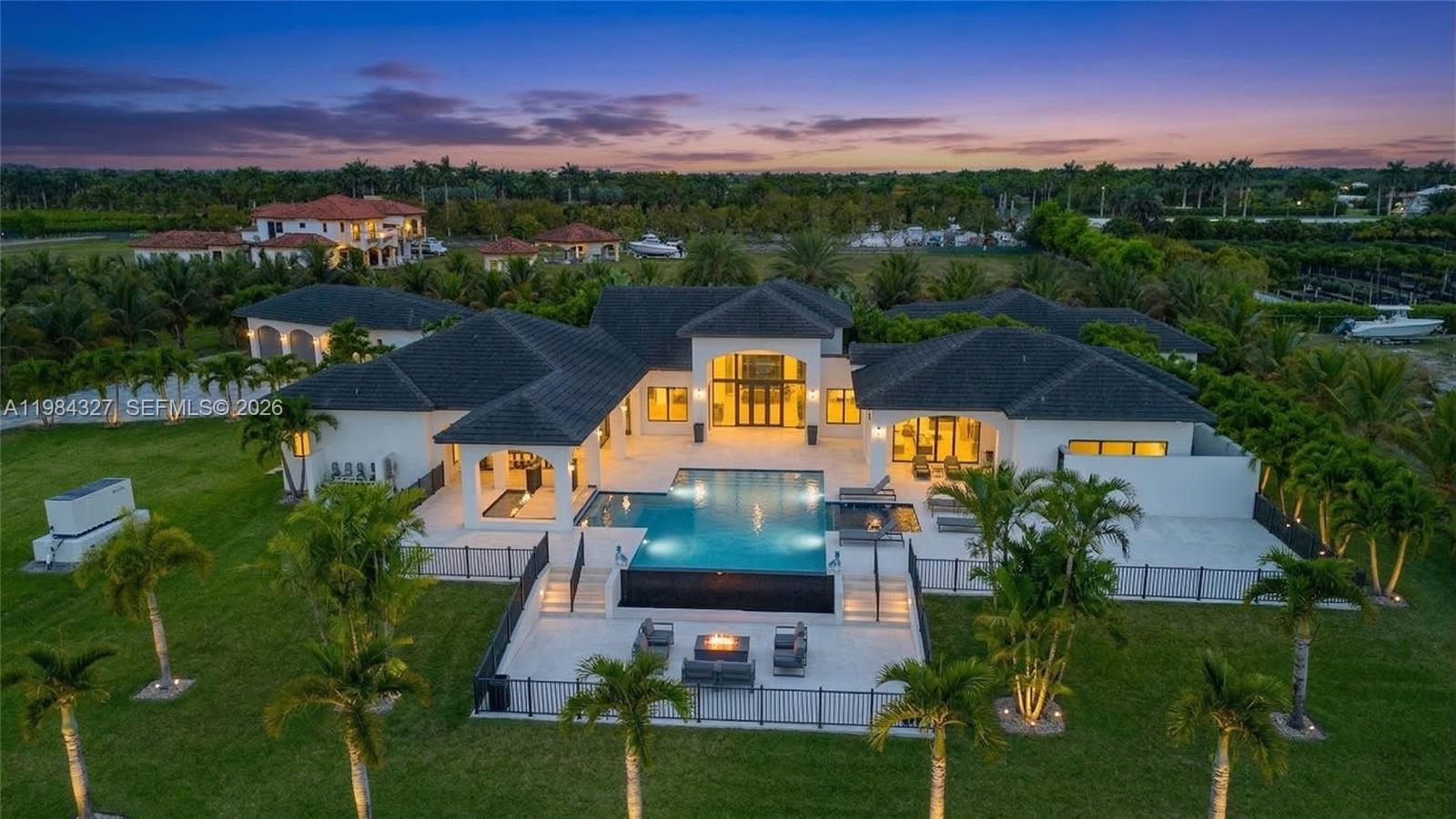 An aerial view of a modern house with a pool, patio, and surrounding lawn — 15620 SW 188th Ct, Miami FL 33187, MIAMI, FL