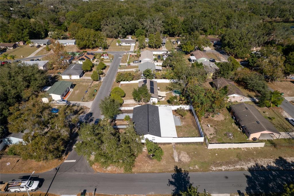 An aerial view shows a residential neighborhood with several single-story houses and tree-lined streets — 5248 KING STREET, ZEPHYRHILLS, FL