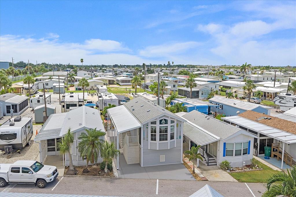 An aerial view shows several manufactured homes and recreational vehicles in a residential community — 4 BASIN STREET, PALMETTO, FL