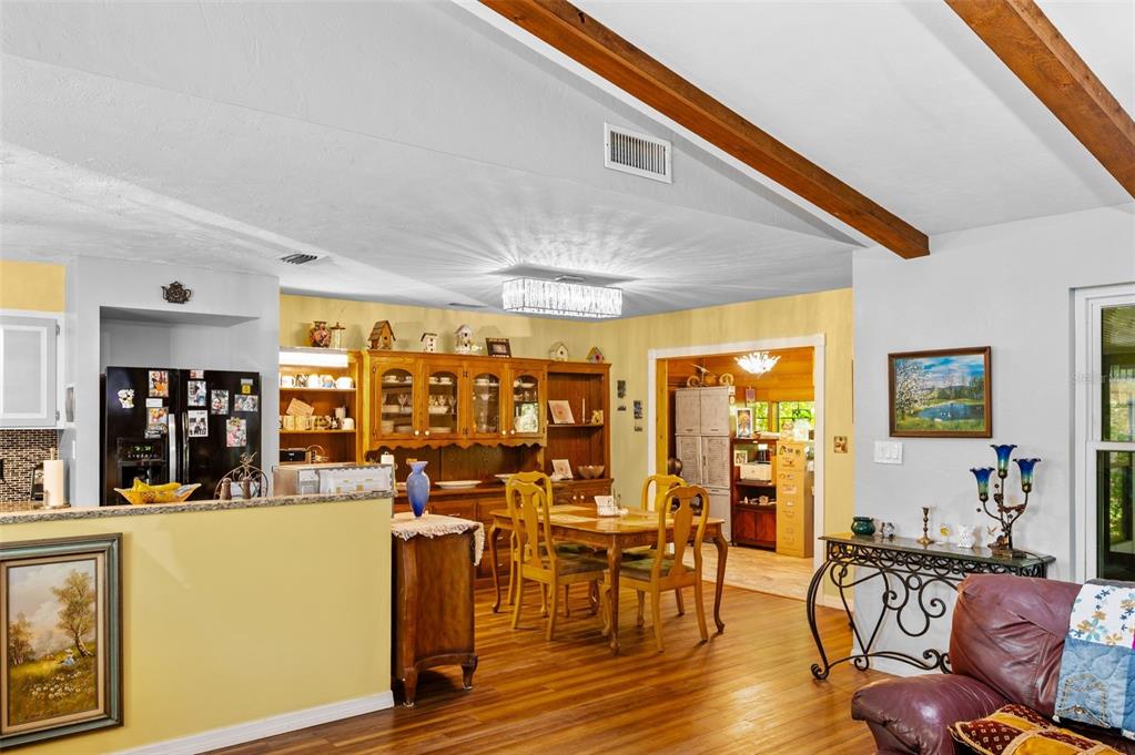 A dining area with wooden furniture and a hutch sits adjacent to a kitchen — 16422 NE 10TH STREET, GAINESVILLE, FL