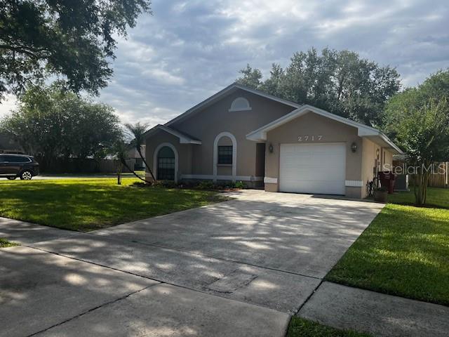 A single-story house with a white garage door and a concrete driveway — 2717 WILDER PARK DRIVE, PLANT CITY, FL