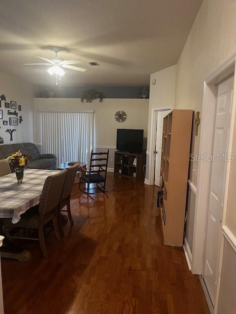 A dining area with hardwood floors leads to a living room with a sliding glass door — 2717 WILDER PARK DRIVE, PLANT CITY, FL