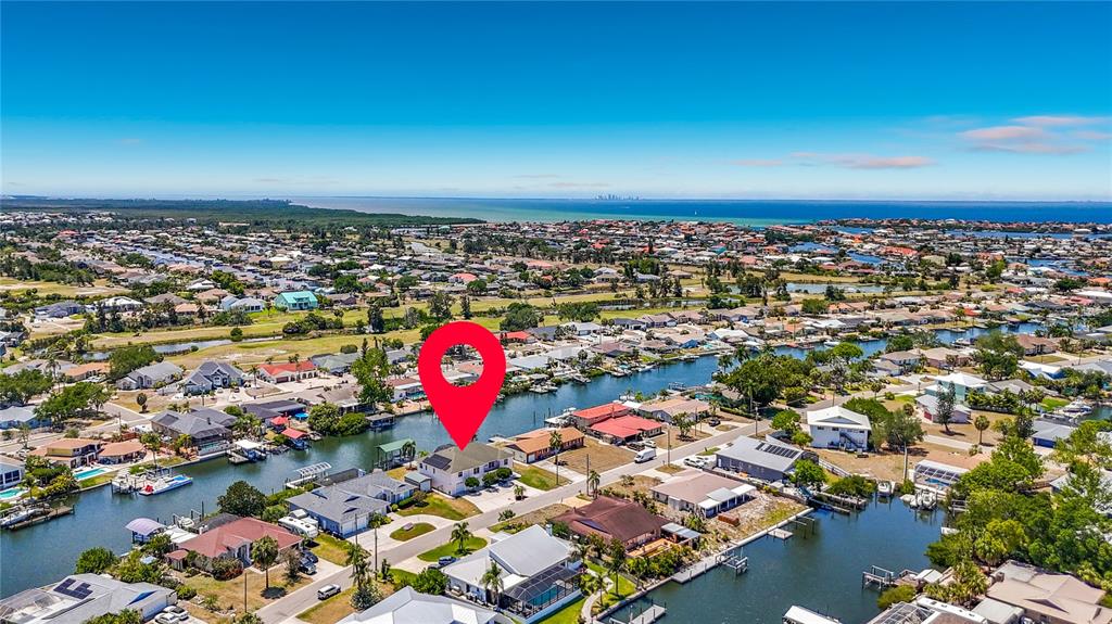 An aerial view shows a waterfront house with a red location pin in a neighborhood — 624 KINGSTON COURT, APOLLO BEACH, FL