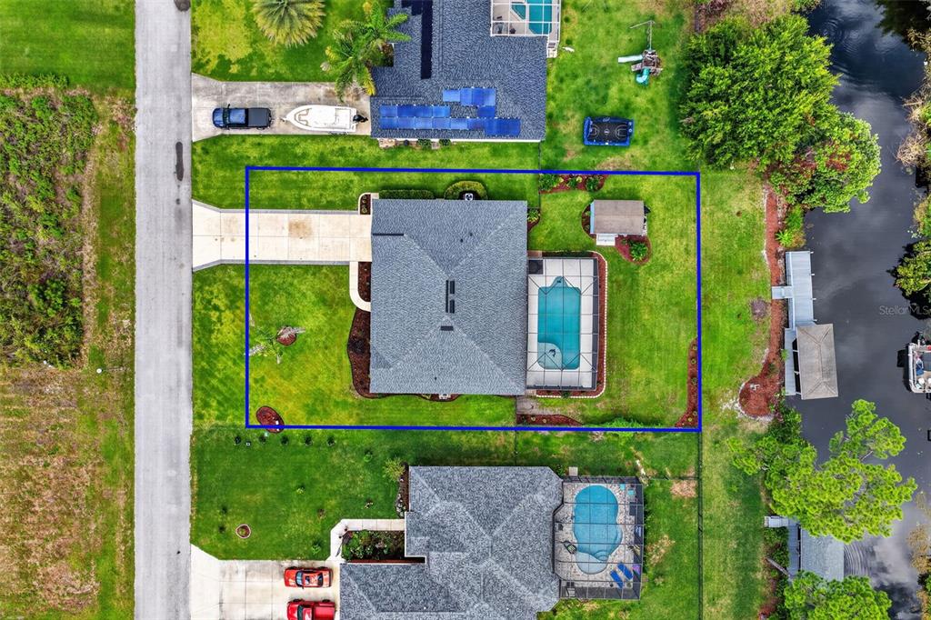 Aerial view of a residential property featuring a house with a pool and shed — 12037 EAGLE POINT CT, LEESBURG, FL