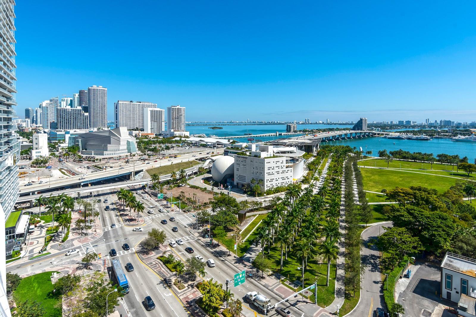 An elevated view shows a Miami cityscape with high-rise buildings, a park, and a bridge — 900 Biscayne Blvd # 2006, Miami FL 33132, MIAMI, FL