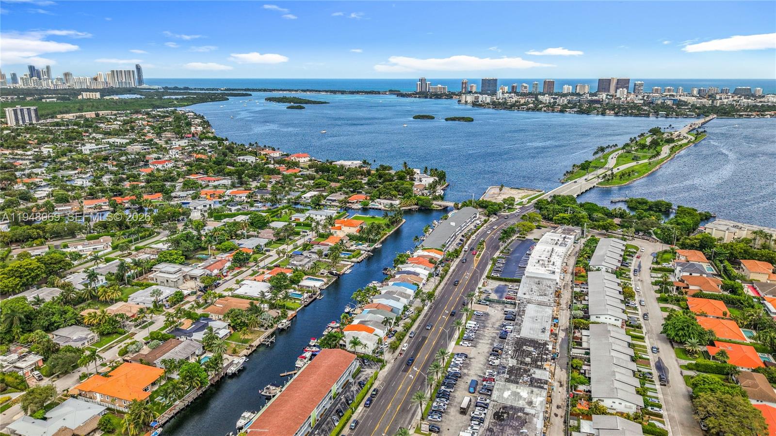 An aerial view shows a canal, a road, residential buildings, and a bridge over water — 2205 NE 123rd St, North Miami FL 33181, NORTH MIAMI, FL