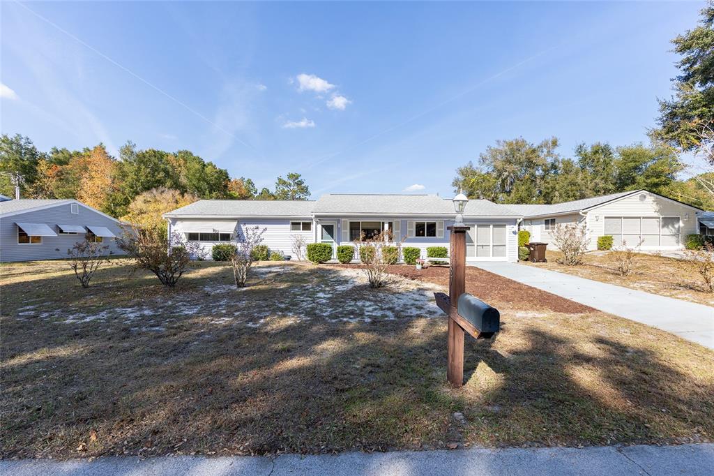 A single-story light blue house with a gray roof and a front yard — 8987 SW 108TH PLACE, OCALA, FL