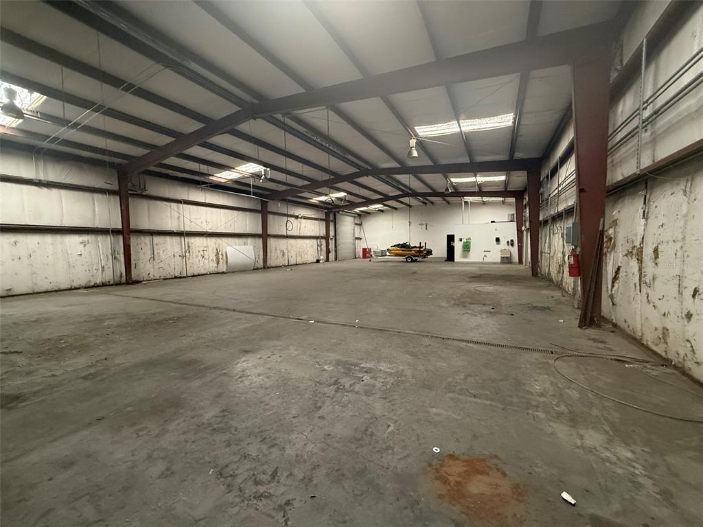 A large, open industrial warehouse space features a concrete floor, metal walls, and exposed beams — 4344 SE 95TH STREET UNIT 1, OCALA, FL