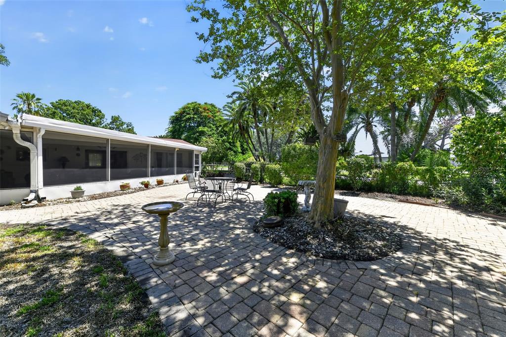 The exterior of a single-story house features a green front door and a concrete walkway — 100 59TH AVENUE S, ST PETERSBURG, FL